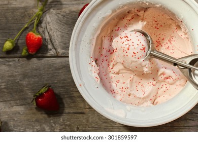 Scoop Of Homemade Strawberry Ice Cream  In Ice Cream Maker, Overhead View