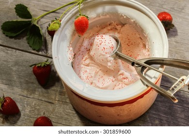 Scoop Of Homemade Strawberry Ice Cream  In Ice Cream Maker, Overhead View