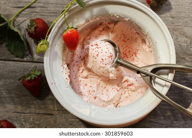 Scoop Of Homemade Strawberry Ice Cream  In Ice Cream Maker, Overhead View