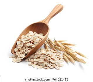scoop and pile of oatmeal with its plant - Shutterstock ID 764021413