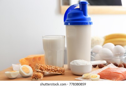 Scoop With Protein Powder, Shake In Bottle And Products On Table