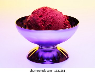 A Scoop Of Rasberry Sorbet In A Colorful Setting.