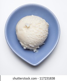 A Scoop Of Vanilla Ice Cream In A Blue Bowl