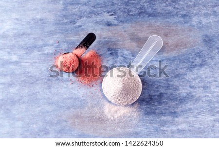 Scoop of Whey Protein and Creatine Powder. Sport nutrition. Rustic wooden background. Top view. Copy space
