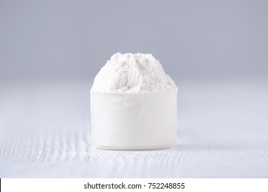 A Scoop With White Powder On Gray Background, Selective Focus