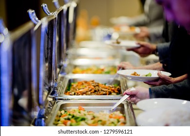 scooping the food, buffet food at restaurant, catering 
