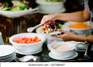 scooping the food, buffet food at restaurant, catering 
