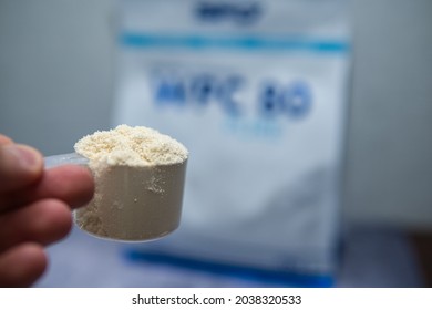 Scooping Up The Whey Protein Concentrate. The Athlete Supplements With Protein. Providing The Body With Protein To Build Muscle