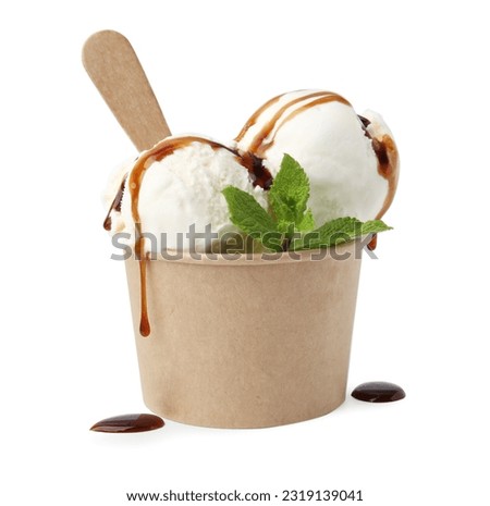 Scoops of delicious ice cream with caramel sauce and mint in paper cup isolated on white