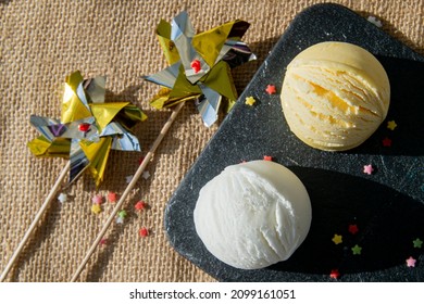 scoops of vanilla ice cream and cream on slate board
