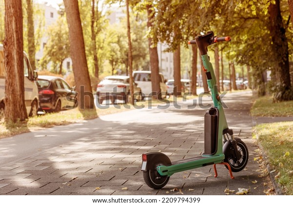 Scooter E-scooter ready for Rent in Park Street.\
Electric Scooter Sharing Service in urban Space Background. Eco\
vehicle concept.