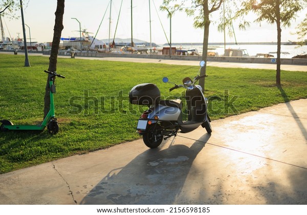 Scooter, motorcycle in the city and near sea on the\
street on a summer day