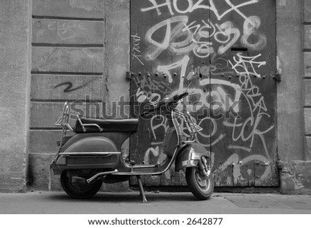 a scooter parked in front of a graphitti sprayed doorway in aix en provence south of france europe