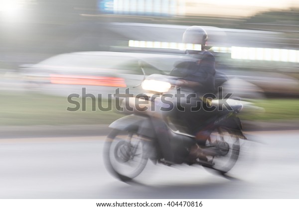 scooter rider on a bike lane in the busy city\
traffic in motion blur