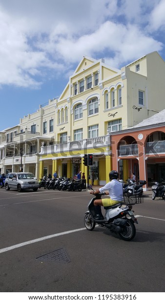 Scooter rider in yellow Bermuda\
shorts  on Front Street in Hamilton, Bermuda.  Oct 1st,\
2018.