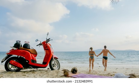 Scooter road trip. Lovely couple on red motorbike in white clothes on sand beach. Wedding just married people walking near tropical palm tree, sea. Honeymoon by ocean. Asia Thailand. Motorcycle rent. - Powered by Shutterstock