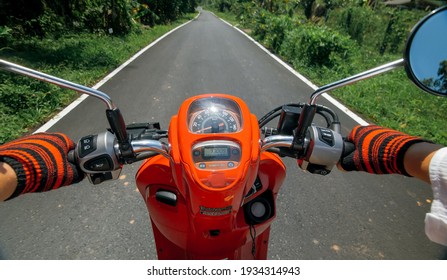 Scooter Road Trip. POV View, First Person. Men On Red Motorbike In White Clothes On Drive Forest Road Trail. Hold The Steering Wheel Motorbike. Motorcycle Rent. Asia Thailand Transport.