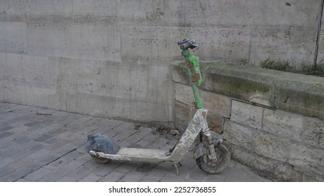 A scooter that was recovered from the Seine, muddy, in poor condition, electronic device damaged and not usable. Parisian incivility, problem of respect and ecology, degradation electronic equipment - Shutterstock ID 2252736855