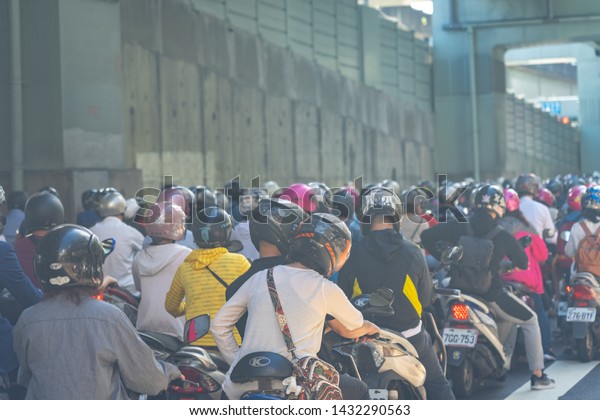 Scooter waterfall in Taiwan. Traffic jam crowded of\
motorcycles at rush hour on the ramp of Taipei Bridge, Cascade of\
scooters on Minquan West Road in Datong District, Taipei, Taiwan :\
21 June 2019