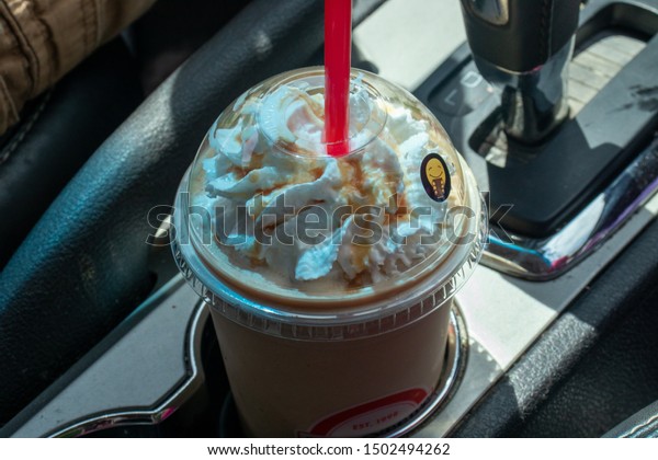 Scooter\'s coffee  caramelicious Blender coffee in car\
cupholder 