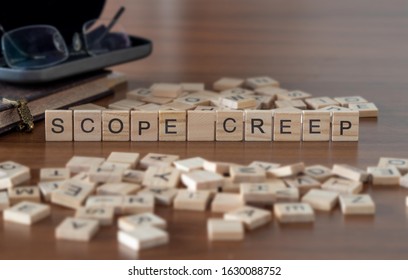 scope creep concept represented by wooden letter tiles - Shutterstock ID 1630088752