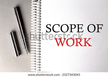 SCOPE OF WORK text on notebook with pen on grey background