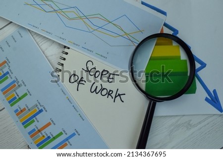 Scope of Work write on a book isolated on Wooden Table.