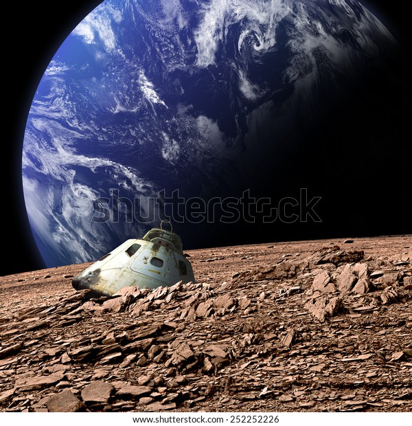 A scorched\
space capsule lies abandoned on a barren moon. An Earth-like planet\
covered in water rises in the background. - Elements of this image\
furnished by NASA.