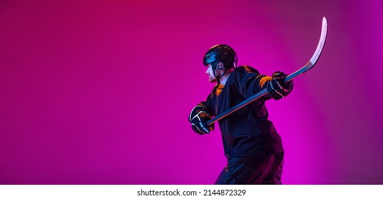 Scoring A Goal. Portrait Of Active Man, Professional Hockey Player In Motion, Training Isolated Over Pink Background In Neon Light. Concept Of Action, Team Sport Game, Energy. Copy Space For Ad