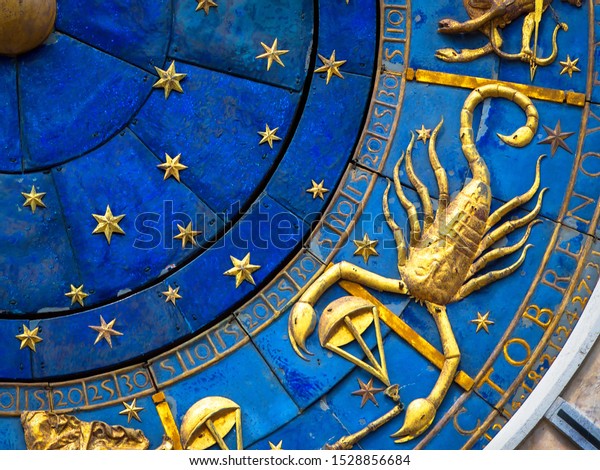 Scorpio astrological sign on ancient clock. Detail of Zodiac wheel with scorpion. Golden horoscope icon of scorpio closeup. Symbol of scorpion on star circle. Astrology concept.