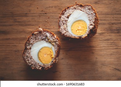 Scotch Egg Cut In Half On Wooden Background