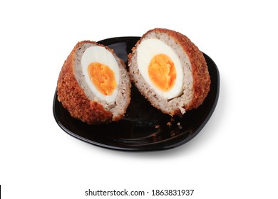 Scotch Egg Cut In Half On Black Porcelain Saucer Close Up