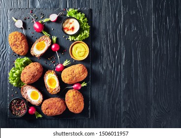 Scotch Eggs, Soft Boiled Eggs With Runny Yolk Wrapped In Minced Meat, Served With Mayonnaise And Mustard On A Black Stone Tray, View From Above, Flatlay, Free Space