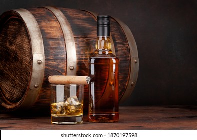 Scotch Whiskey Bottle, Glass, Cigar And Old Wooden Barrel. With Copy Space