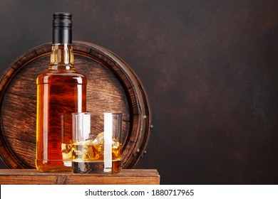 Scotch whiskey bottle, glass and old wooden barrel. With copy space - Powered by Shutterstock