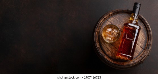 Scotch Whiskey Bottle, Glass And Old Wooden Barrel. With Copy Space. Top View Flat Lay