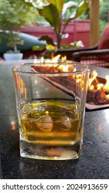 Scotch Whiskey Cocktail By A Gas Fireplace Patio In The Backyard Garden