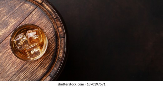 Scotch Whiskey Glass And Old Wooden Barrel. With Copy Space. Top View Flat Lay