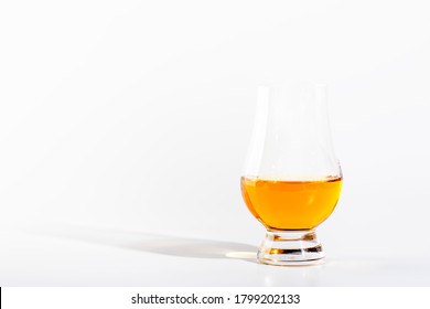 Scotch Whiskey without ice in glass, white background, copy space 
