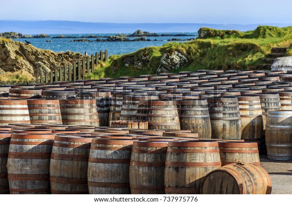 Scotch whisky barrels lined up seaside on the Island of\
Islay, Scotland UK 