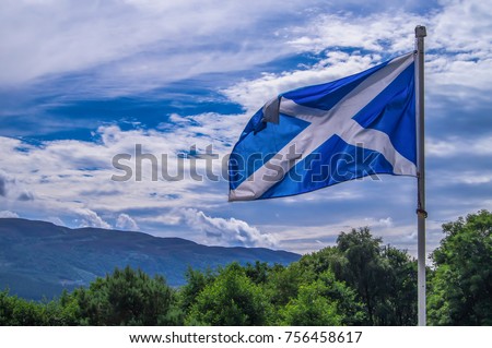 Scotland flag waving wind cloudy day at Loch Ness Highlands