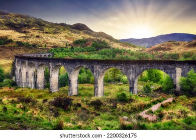 Scotland Landscape - Glenfinnan Train Viaduct At Dramatic Sunset With Sun, UK