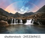 Scotland - Rainbow over Fairy pools waterfall in Isle of Skye, UK