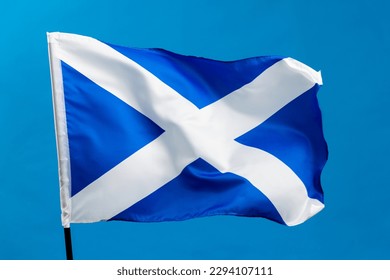 Scottish flag waving on blue background.