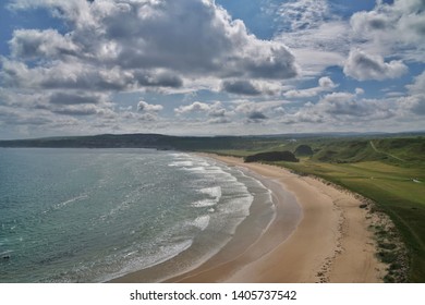 The Scottish Highlands Beautiful Sweeping Sandy Cullen Beach Flanked By The Moray Firth And A Typical Links Golf Course. Blues Skies And Fluffy Clouds Above.