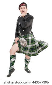 Scottish Man In Traditional National Costume With Blowing Kilt Isolated