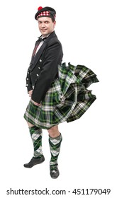 Scottish Man In Traditional National Costume With Blowing Kilt Isolated