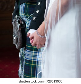 Scottish Wedding With Bride And Groom Holding Hands With Kilt Sporran And Dress