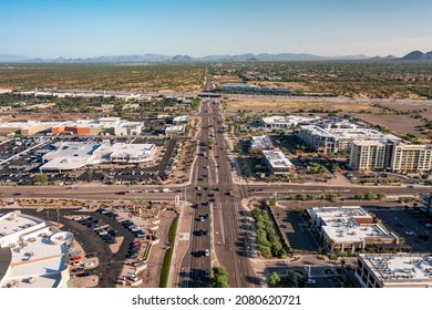 Scottsdale, Arizona USA - October 1 2021: Aerial View Of Commercial And Residential Buildings Along Road With Landscape In The Distance 