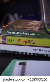 Scottsdale, AZ USA 12 28 2020: Sayuri Raw Food Cafe Cookbooks On Table With Natural Daylight